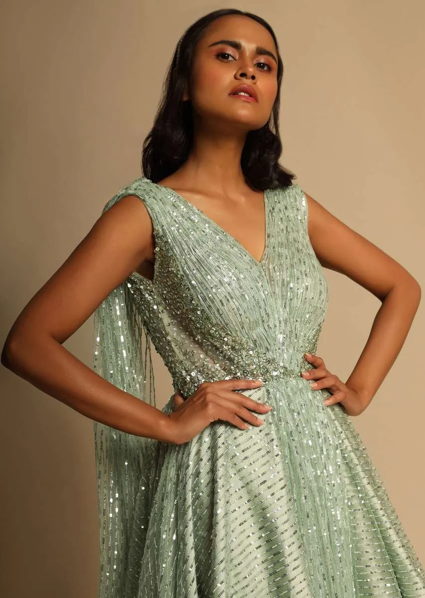 Mint Green Gown In Sequins Embellished Net With Ruching In The Front, Sheer Sides And Net Cape On Each Shoulder Online - Kalki Fashion